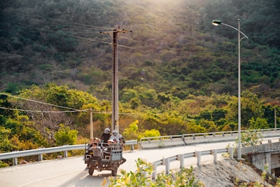 Passengers enjoying a breezy open-air ride through lush island trails