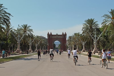 people running and riding bicycles on cement barcelona teams background