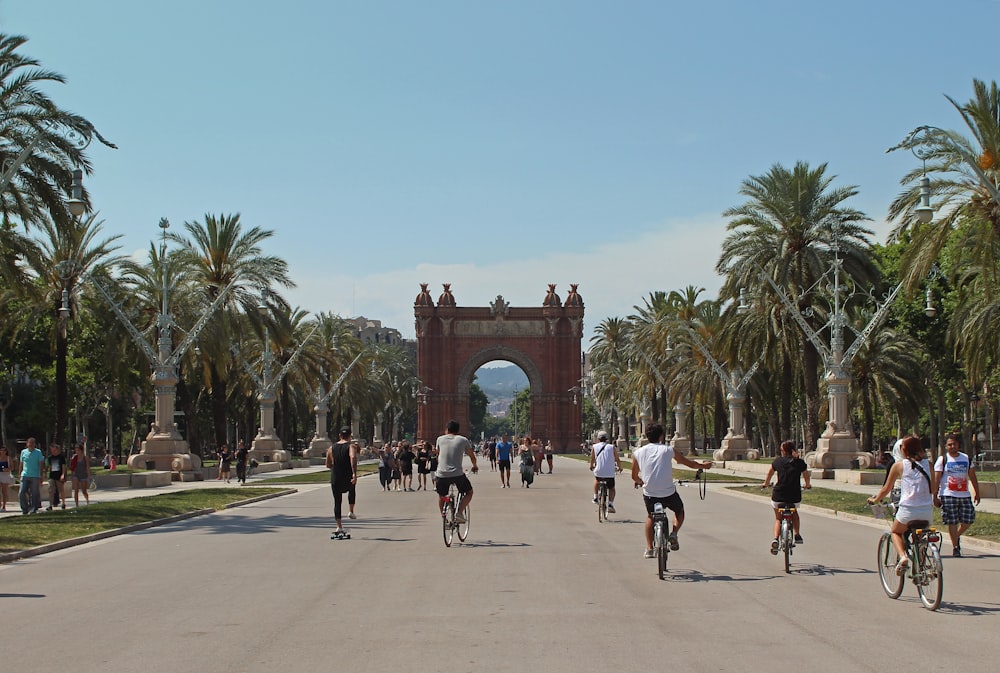 people running and riding bicycles on cement