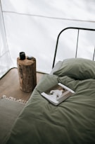 magazine in green bed near green pillow