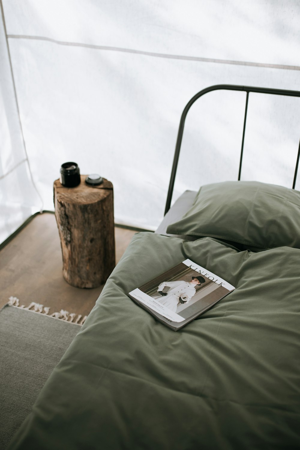 magazine in green bed near green pillow