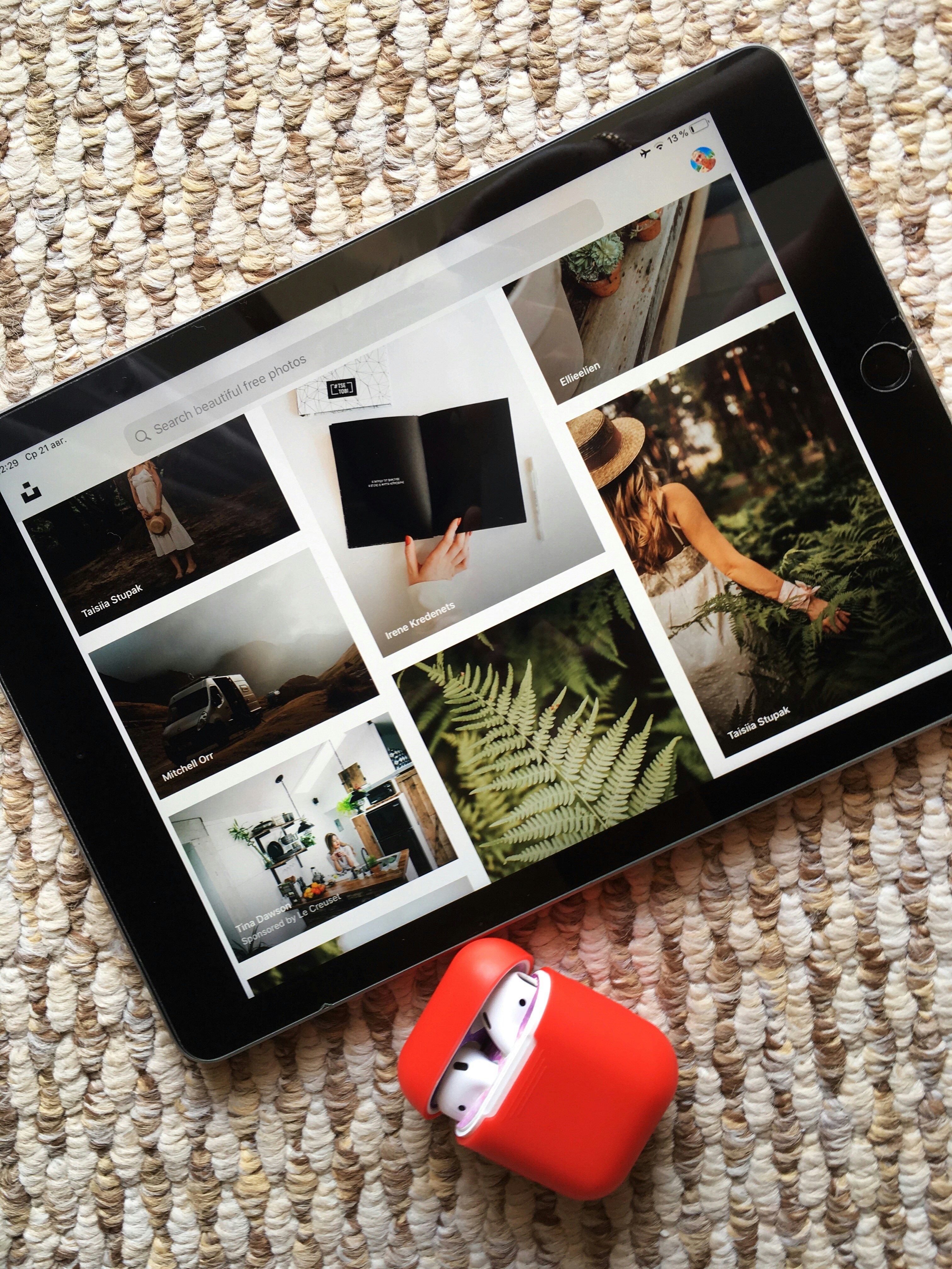 black tablet near red box on a brown textile