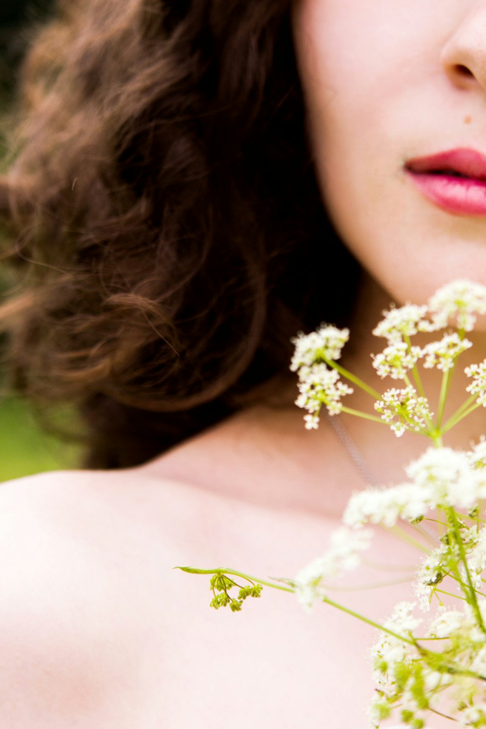 a close up of a woman holding a bunch of flowers