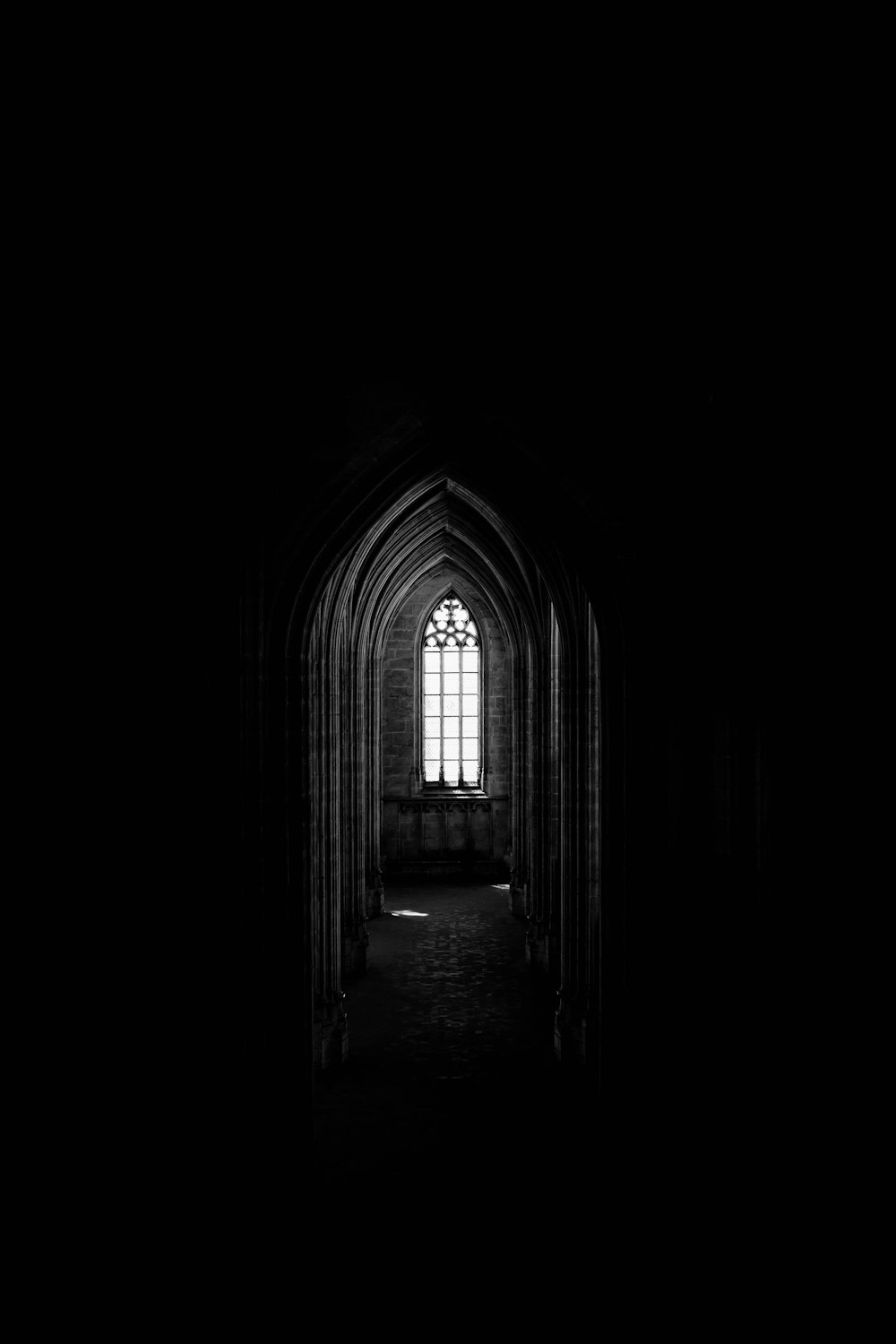 a black and white photo of a dark hallway