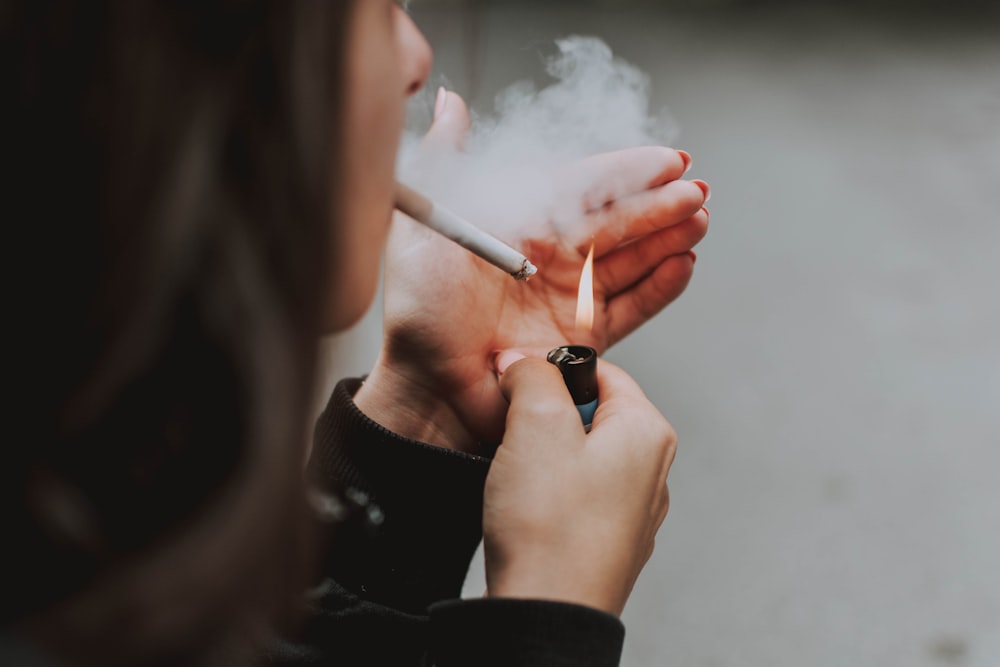 woman lights her cigarette with lighter