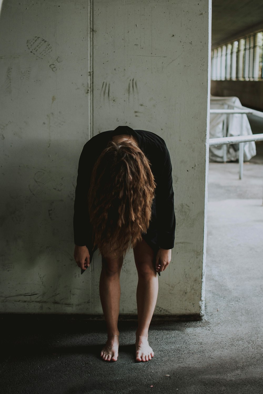 woman wearing black sweater facing down