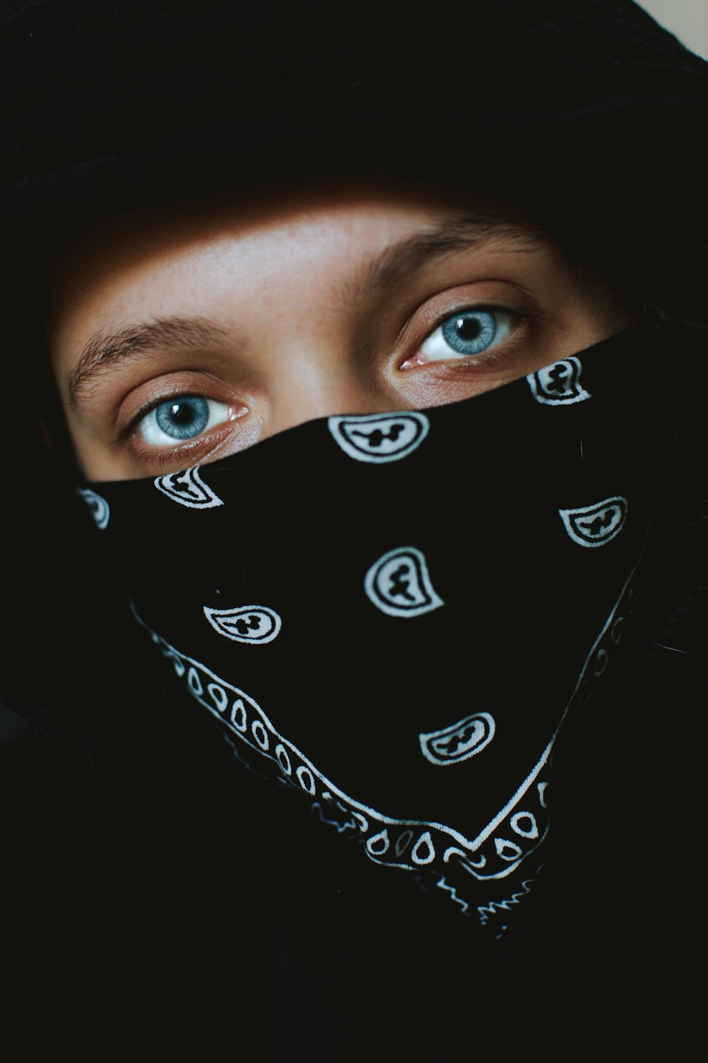 person in black and white paisley bandana