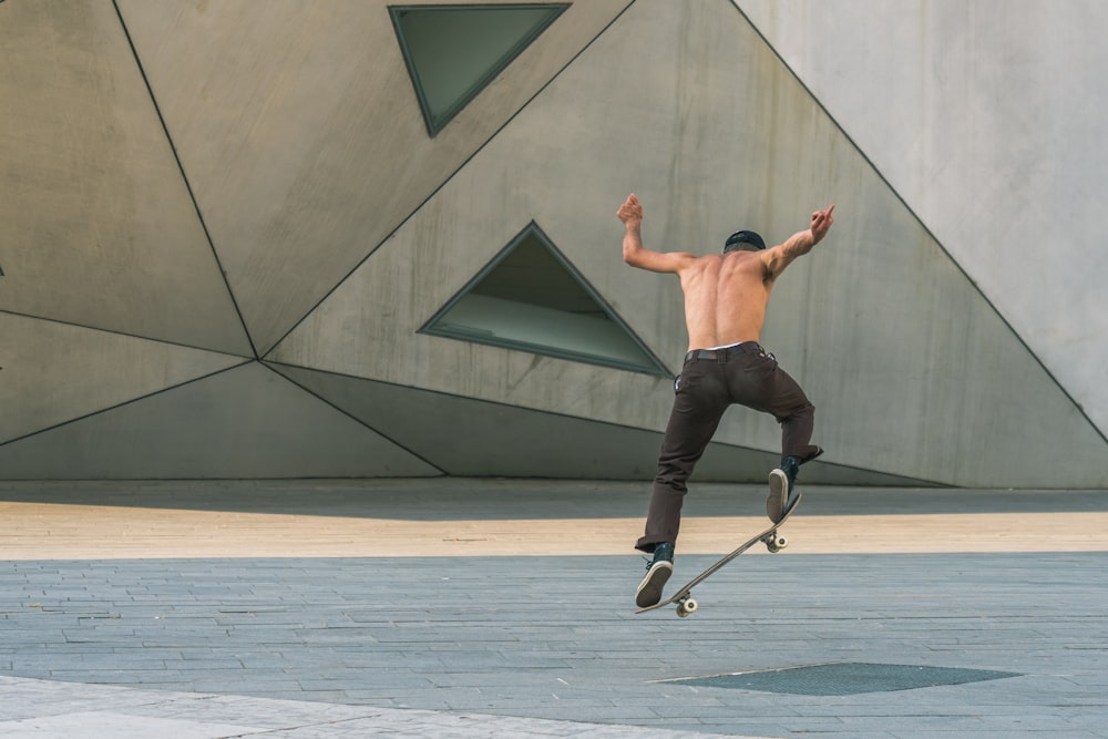man doing tricks on a skateboard in mid air