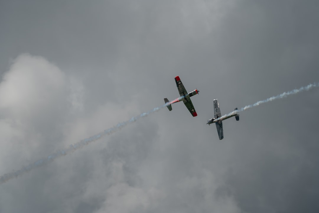 two gray planes under white clouds