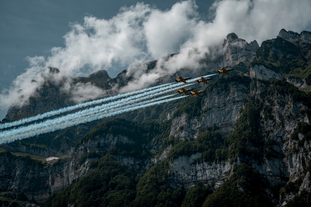 five planes under white clouds