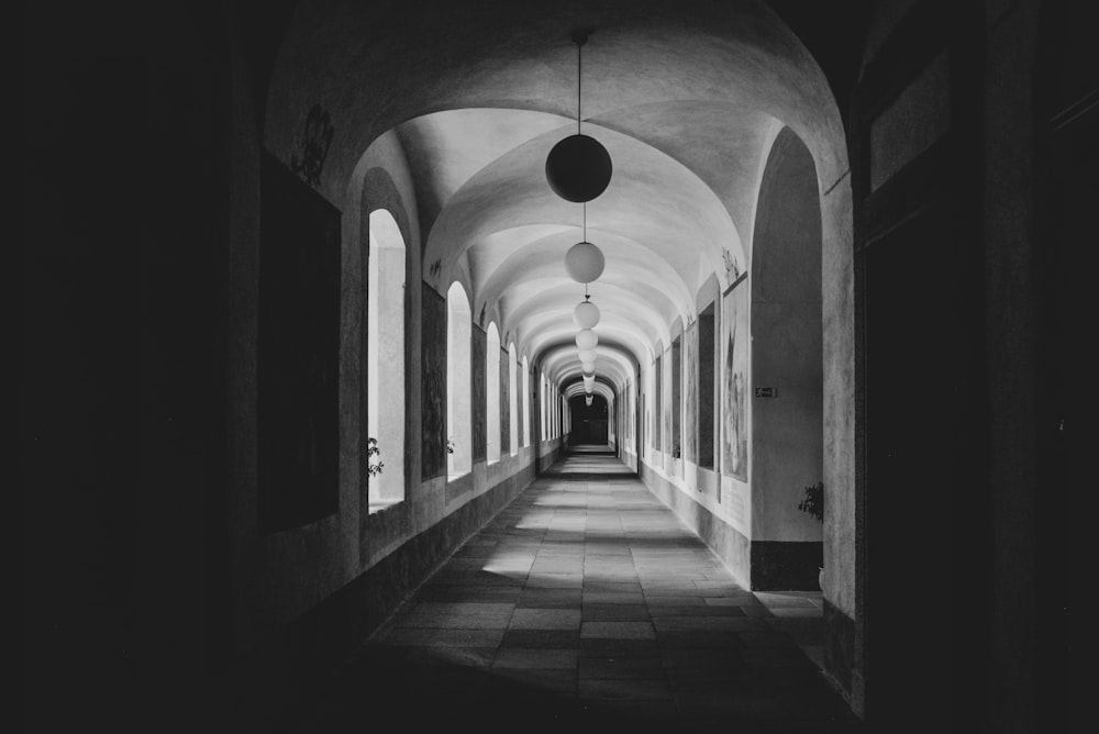 grayscale photo of empty corridor