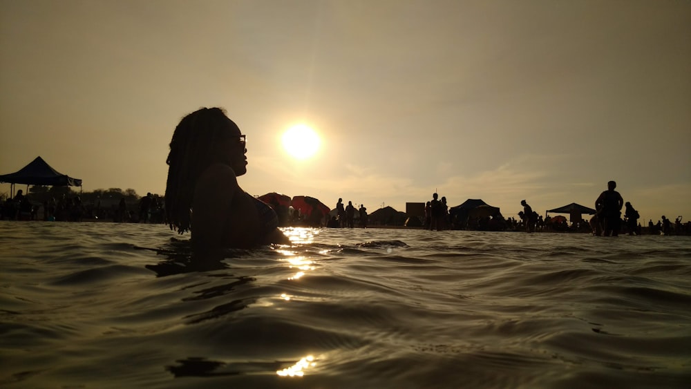 silhouette photography of man on body of water