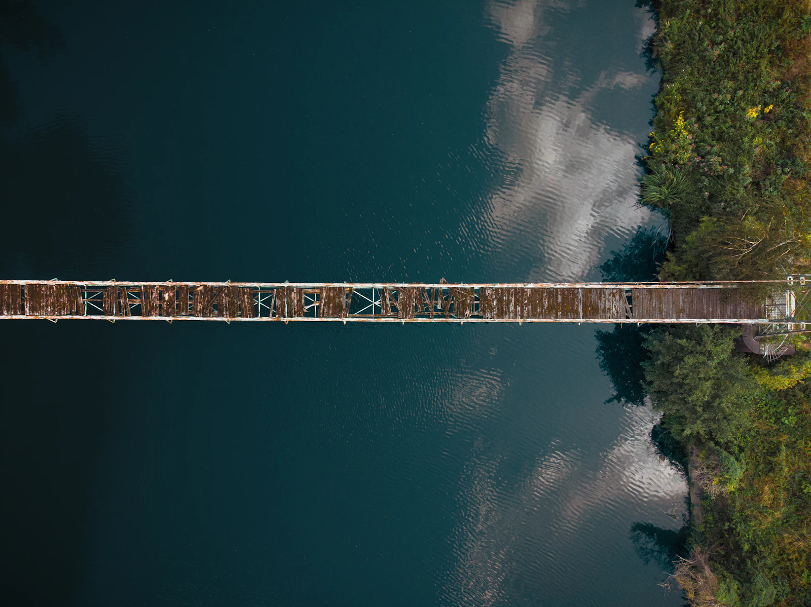 Aerial view of a broken suspension bridge, illustrating neutralized backlinks that no longer pass ranking value
