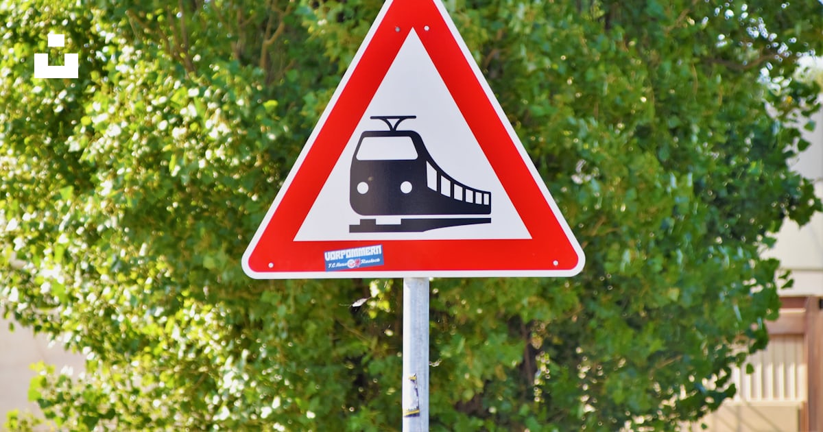 Train road sign near green tree photo – Free Greifswald Image on Unsplash