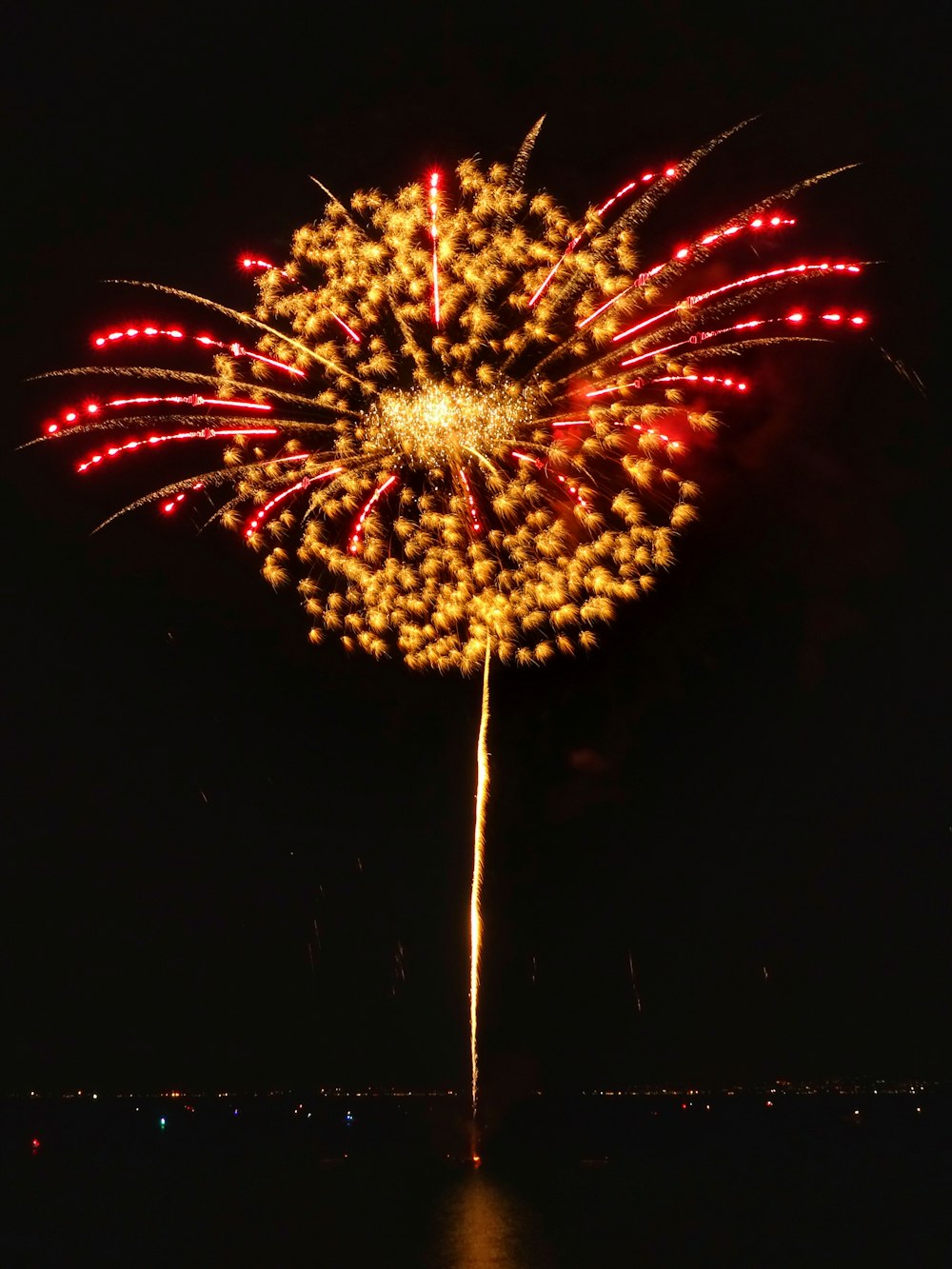 long-exposure photography of yellow and red fireworks