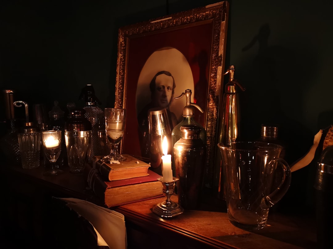 Candle, books, portrait on the piano in an ald mansion transformed in a bar in Dijon, Burgundy France.