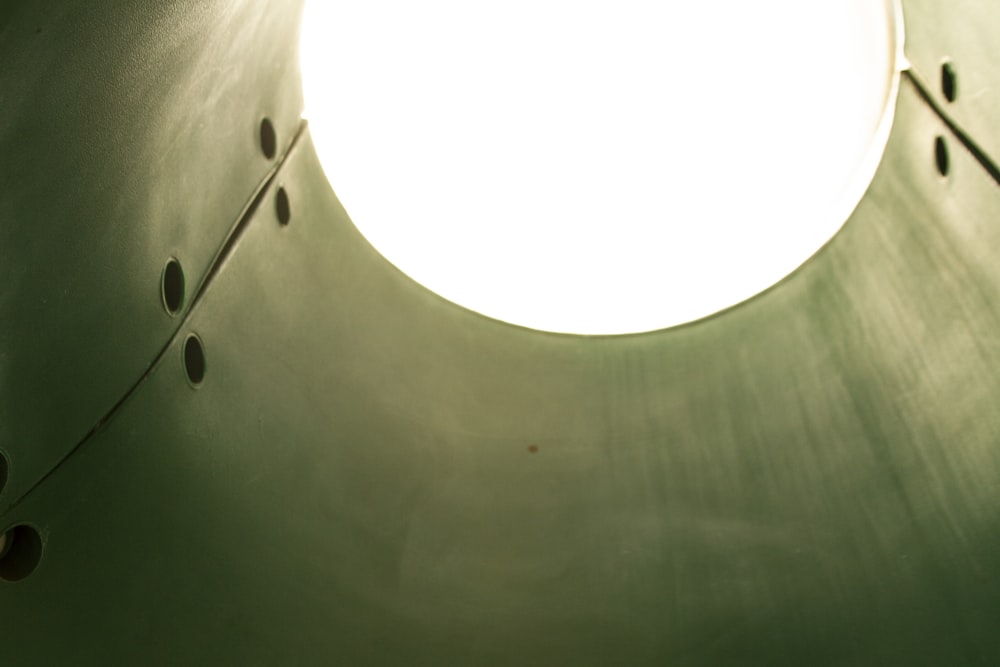 a round light hanging from a ceiling in a room