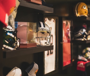 brown football and gray helmet on brown rack