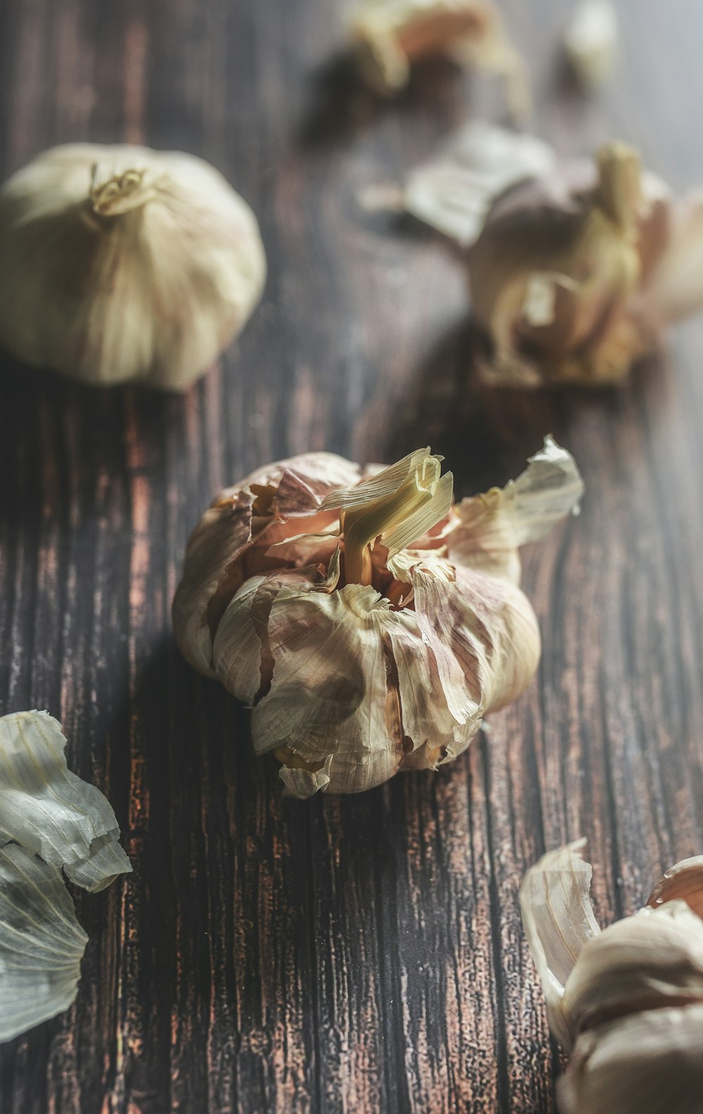 garlic bulbs on brown surface