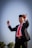 man wearing formal suit standing and beating using stick