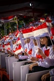 shallow focus photo of people holding Indonesia flag