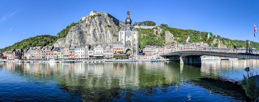 grey concrete buildings beside calm body of water