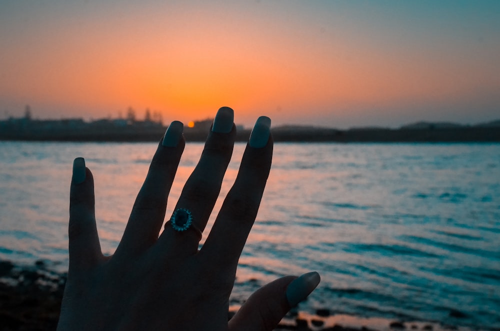 person wearing silver-colored ring