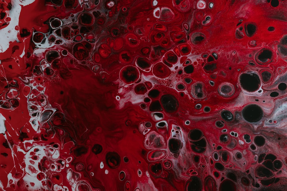 a red and black painting with lots of bubbles
