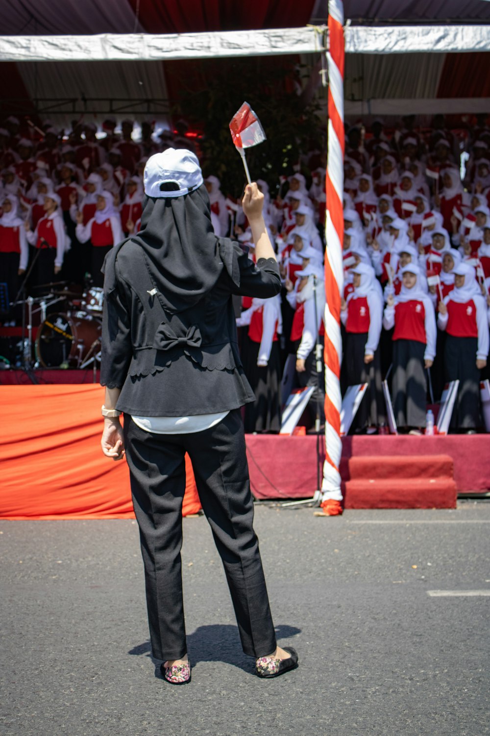 woman stands in front of people