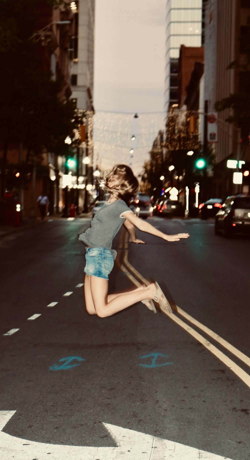 woman jumping on road