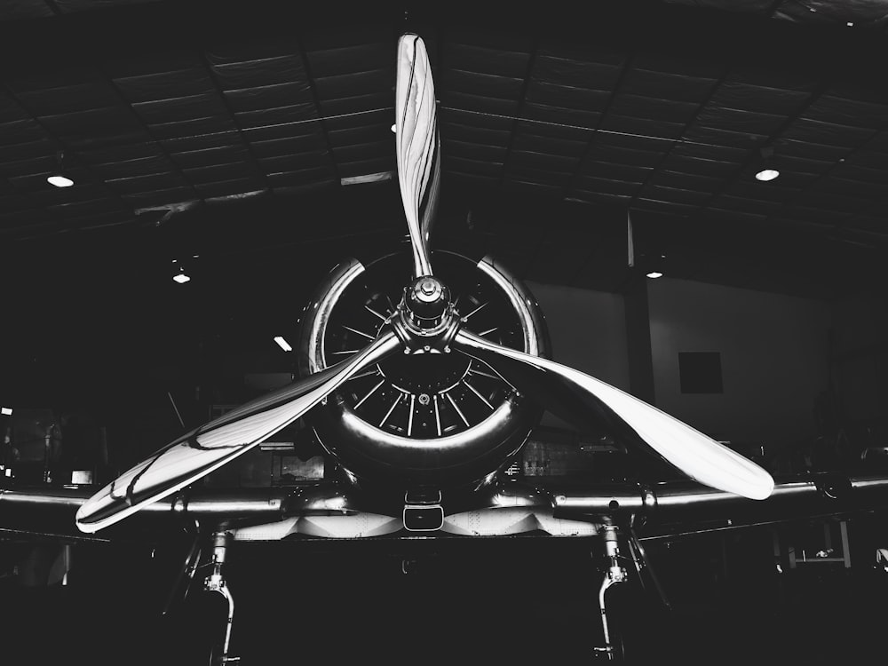 grayscale photography of plane with 3-propeller