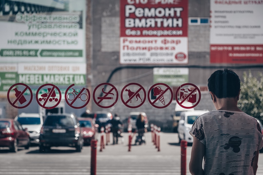 person standing beside glass wall