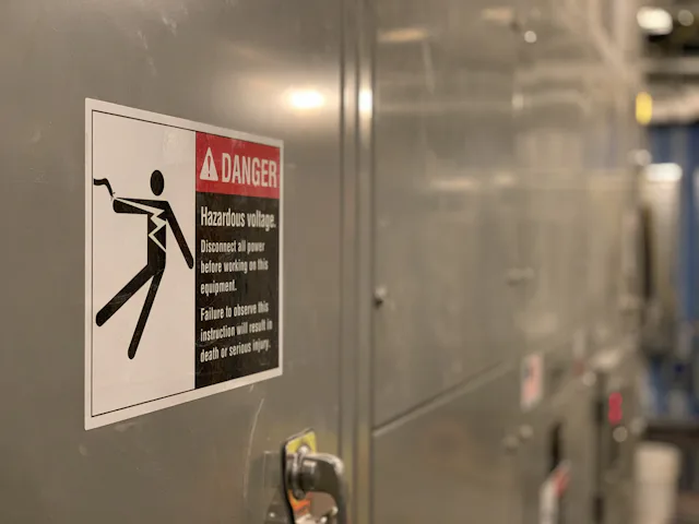 High voltage warning signage representing electrical surge risk