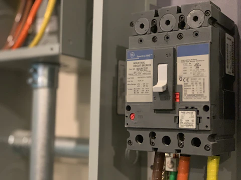 Circuit breaker being wired and installed to code