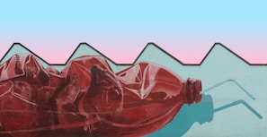 A vibrant street mural featuring the 'échate un trago' water bottle with electric blue and black accents.