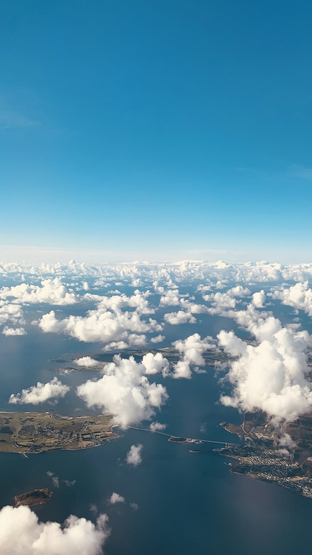 body of water under white clouds