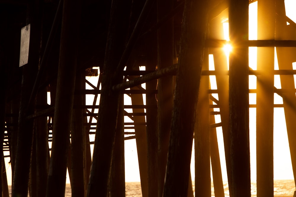 the sun is shining through a wooden structure