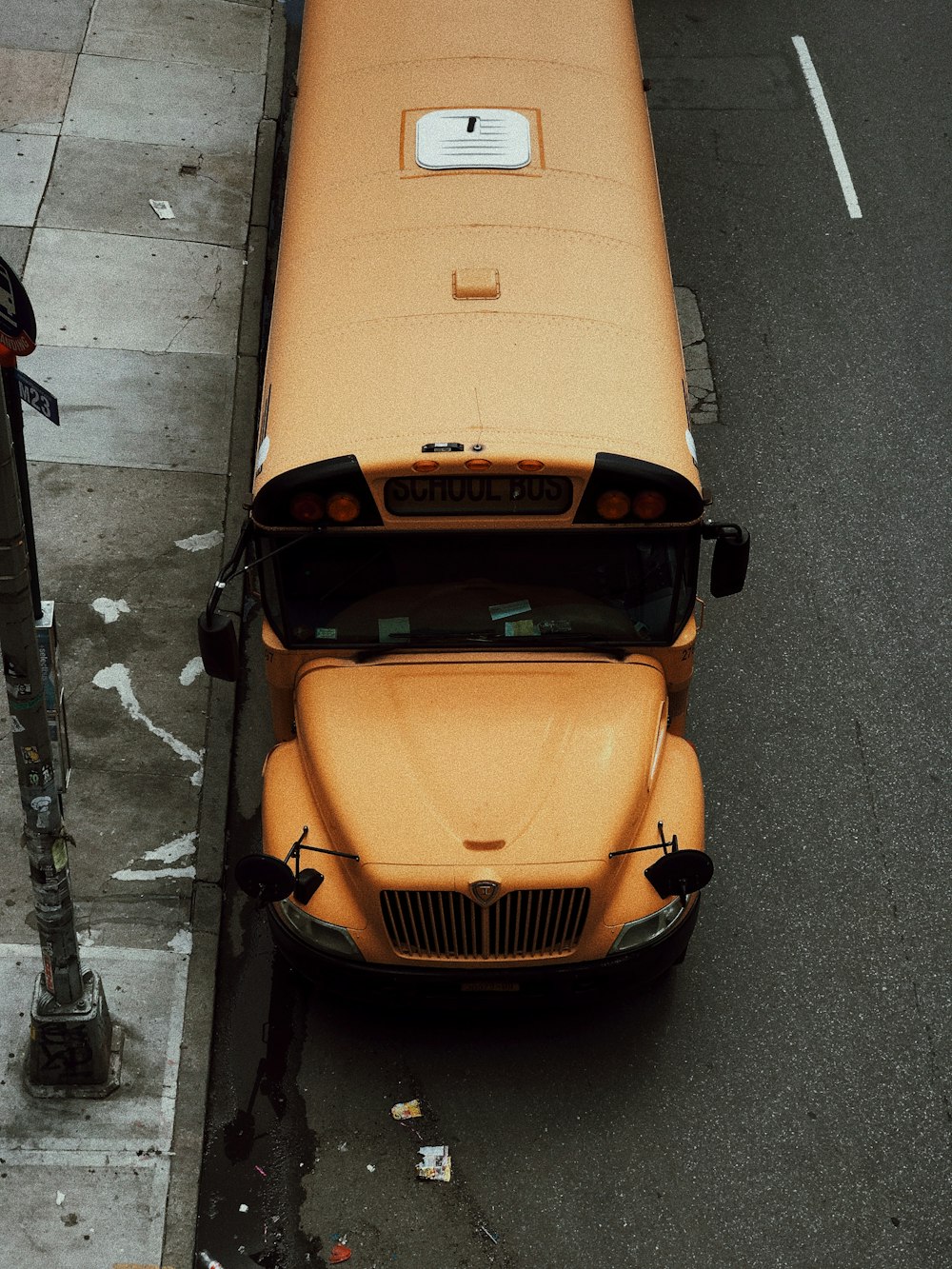 school bus parked beside curb during day