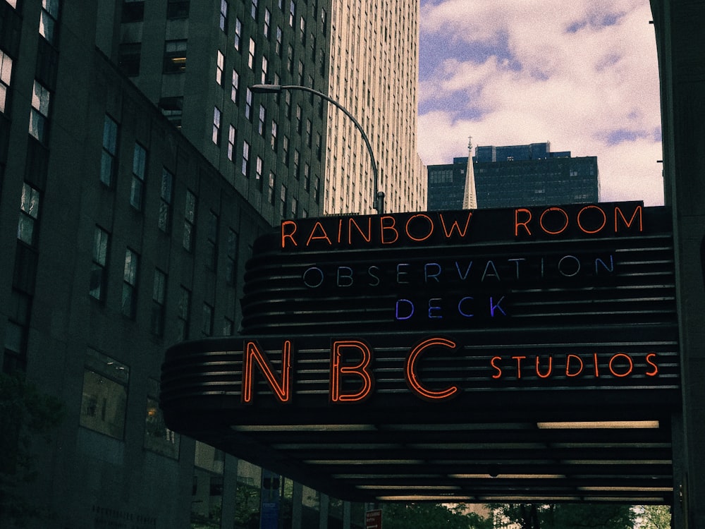 neon signage of building displaying rainbow room