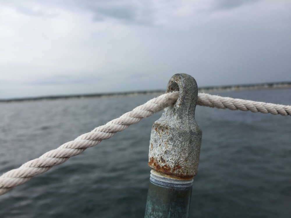 boat rope tied into gray pillar