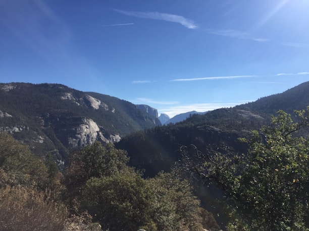 A scenic view of the mountainous landscape surrounding Cavnic, showcasing lush greenery and clear blue skies.