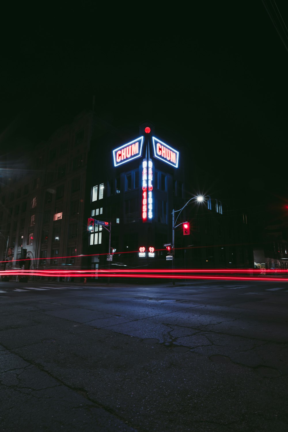 a large building with a neon sign on top of it