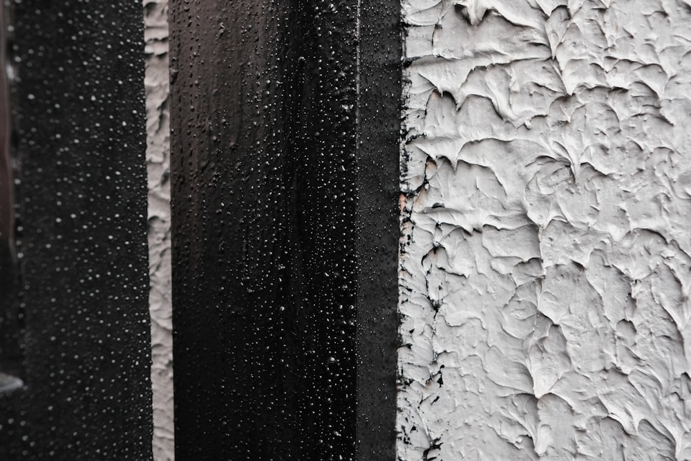 a close up of a wall with rain drops on it