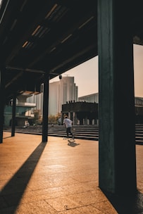Skater riding a HimalayanDeck board on a sunlit urban street in India.