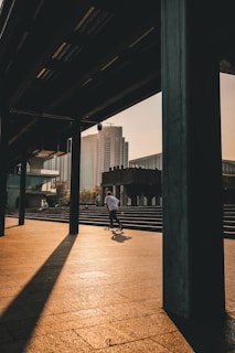 Skater riding a HimalayanDeck board on a sunlit urban street in India.