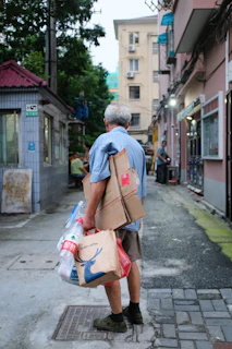 man carrying cardboard boxes