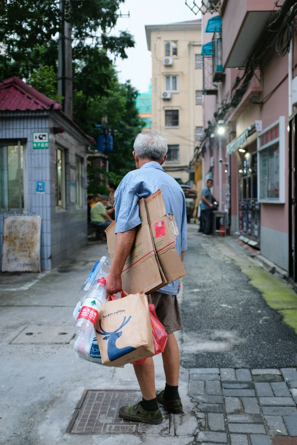 man carrying cardboard boxes