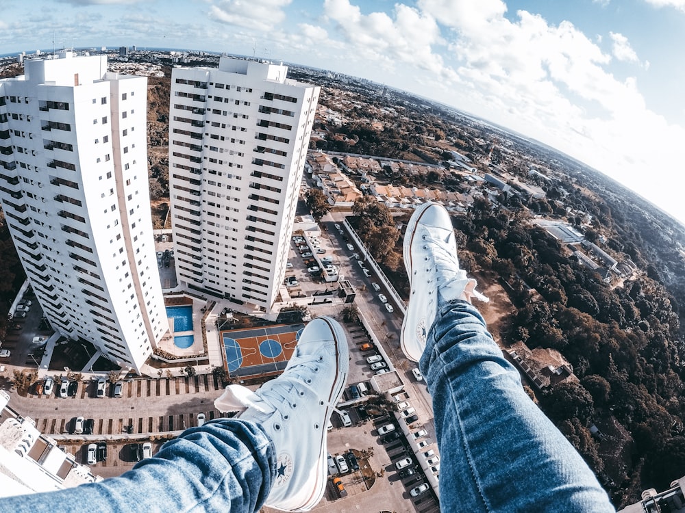 person sitting on high rise building roof top