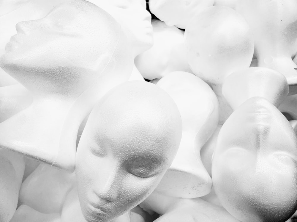 pile of white mannequin heads