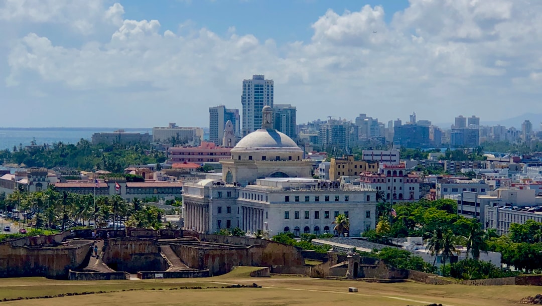 aerial photo of city buildings under cloudy sky,